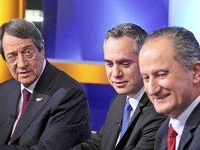 FILE - In this file photo dated Monday, Jan. 22, 2018, with the three front running presidential candidates, from left, Cyprus' President Nicos Anastasiades, Nicolas Papadopoulos, and Stavros Malas, prior to their live televised debate in capital Nicosia, Cyprus.  Cypriots will vote upcoming Sunday in presidential elections with critical topics including the reunification of the divided island and economic recovery, likely to be decisive in the vote.