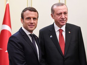 FILE - This is a Thursday May 25, 2017  file photo of French President Emmanuel Macron, left, and Turkish President Recep Tayyip Erdogan as they pose during their meeting which is on the sidelines of the NATO summit, in Brussels.  Erdogan is trying to bring Turkey's relations with European nations back on track following a stormy 2017 that saw the Turkish leader quarrel with European leaders and accuse them of Nazi-like behavior. Erdogan travels to Paris on Friday Jan. 5, 2018. for talks with French President Emmanuel Macron.