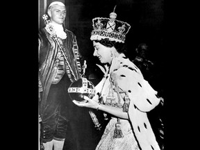 FILE - In this June 2, 1953 file photo, Britain's Queen Elizabeth II wearing the bejeweled Imperial Crown and carrying the Orb and Scepter with Cross, leaves Westminster Abbey, London, at the end of her coronation ceremony. Queen Elizabeth II reveals the secrets of giving a speech while wearing a weighty crown, in unusually candid comments that are part of a new documentary to be aired on the BBC on Sunday Jan. 14, 2018, on her coronation and the symbolism of the crown jewels. (AP Photo/File)