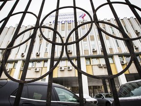FILE - In this Wednesday Dec. 6, 2017 file photo, the building of the Russian Olympic Committee is seen through a gate decorated with the Olympic rings in Moscow, Russia. The International Olympic Committee says it has created a pool of 389 Russians who are eligible to compete under a neutral flag at next month's Winter Olympics amid the country's doping scandal.