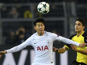 FILE - In this Tuesday, Nov. 21, 2017 file photo, Tottenham' Hotspurs Son Heung-min, left, and Dortmund's Marc Bartra challenge for the ball during the soccer Champions League group H match between Borussia Dortmund and Tottenham Hotspur in Dortmund, Germany. Son Heung-min is in the form of his life at Tottenham at the start of a year when he will carry South Korea's hopes at the World Cup and the Asian Games. There's a growing appreciation of the South Korean's artistry and end product that is establishing him as one of the best forwards in England.