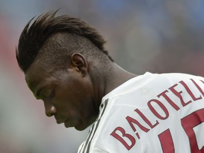 FILE - In this Sunday, March 6, 2016 file photo, AC Milan's Mario Balotelli looks down during a Serie A soccer match against Sassuolo, at Reggio Emilia's Mapei stadium, Italy. Mario Balotelli's return to top form with Nice owes much to the astute guidance of coach Lucien Favre. He has matched his career-best 18 goals and is thriving on the responsibility of leading Nice's attack.