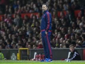 FILE - In this file photo dated Saturday, Dec. 19, 2015, Manchester United's assistant manager Ryan Giggs stands on the touchline during English Premier League soccer match against Norwich City at Old Trafford Stadium in Manchester, England. Ryan Giggs will become manager of Wales soccer team, according to an announcement Monday Jan. 15, 2018, his first managerial job since ending an illustrious playing career.