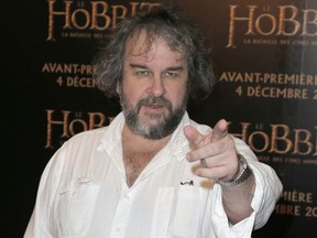 FILE - In this file photo dated Thursday, Dec. 4, 2014, director Peter Jackson poses for photos at the screening of his film The Hobbit.  It is announced Monday Jan. 22, 2018, that Jackson is transforming grainy black-and-white archive film from the London Imperial War Museum using cutting-edge digital technology and hand coloring to transform World War I film into 3-D color, to mark the centenary of the 1914-18 conflict.