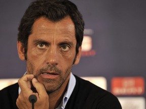 FILE - In this Wednesday Sept. 15, 2010 file photo, Atletico's head coach Quique Sanchez Flores attends a news conference at the Kleanthis Vikelidis stadium in Thessaloniki, Greece. Quique Sanchez Flores will stay as coach of Spanish team Espanyol following interest in him from English club Stoke City.