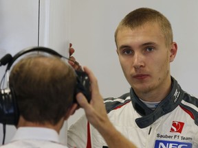 FILE - A Friday, Oct. 10, 2014 file photo of Sauber Russian driver Sergey Sirotkin watching a monitor in the pit during the first free practice at the Sochi Autodrom Formula One circuit, in Sochi, Russia. Sergey Sirotkin has been chosen ahead of Robert Kubica to drive for Williams in this year's Formula One championship.