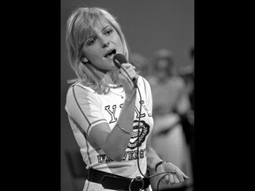 FILE - In this June 4, 1970 file photo, French singer France Gall performs on stage during the 'Deutsche Schlagerwettbewerb', a German song contest, in Mainz, West Germany. Gall, who collected hits and sold millions of albums over a four-decade career, has died. She was 70. Her agent Genevieve Salama told The Associated Press that the singer, with her signature blond bangs, died of cancer in the Paris region on Sunday, Jan. 7, 2018. French President Emmanuel Macron wrote in a tweet that Gall "lasted through time thanks to her sincerity and generosity", leaving "songs known to all French."