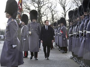 French President Emmanuel Macron views a guard of honour at the Royal Military Academy Sandhurst, near Camberley England  ahead of UK-France summit talks Thursday Jan. 18, 2018.