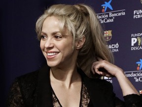 FILE - In this March 28, 2017 file photo, Colombian singer Shakira smiles before a press conference for a charity event at the Camp Nou stadium in Barcelona, Spain. Judicial authorities in Spain said on Tuesday, Jan. 23, 2018 pop music star Shakira is under investigation for possible tax evasion during the three years before she officially moved to Barcelona. Shakira switched residences in 2015 from Bahamas to Barcelona, where she lives with her partner, Barca soccer player Gerard Pique, and the couple's two sons.