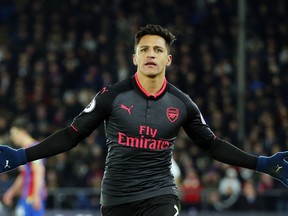 FILE - In this Thursday, Dec. 28, 2017 file photo, Arsenal's Alexis Sanchez celebrates after scoring his side's third goal of the game during their English Premier League soccer match against Crystal Palace at Selhurst Park stadium in London. Alexis Sanchez is close to joining Manchester United in what is set to be a rare swap deal among two of England's top teams that will see Henrikh Mkhitaryan move to Arsenal. Both players were pictured by British newspapers Monday, Jan. 22, 2018 entering an office in Liverpool to update their work permits.