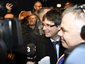 Ousted Catalan leader Carles Puigdemont, center, arrives in Copenhagen on Monday, Jan. 22, 2018. The fugitive former leader of Catalonia has arrived in Denmark, despite threats from Spain to seek his immediate arrest there. Puigdemont is being investigated by Spain over a unilateral declaration of independence by Catalonia's parliament on Oct. 27.