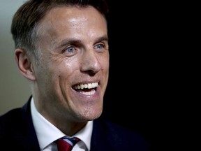 Newly appointed head coach for the England women's soccer team, Phil Neville speaks to the media during his official unveiling at St George's Park, in Burton, England, Monday, Jan. 29, 2018.