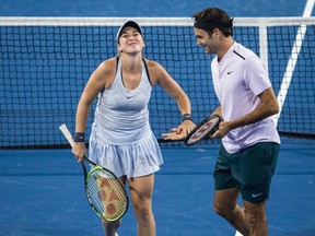 FILE - This is a  Tuesday, Jan. 2, 2018 file photo of Belinda Bencic, left, and Roger Federer of Switzerland as they clap hands during their mixed doubles match against Karen Khachanov and Anastasia Pavlyuchenkova of Russia at the Hopman Cup tennis tournament in Perth, Australia.  Roger Federer and Belinda Bencic advanced Switzerland into the Hopman Cup final with straight-set singles victories over their American opponents.