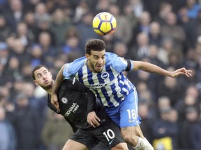 Chelsea's Eden Hazard, left, and Brighton & Hove Albion's Connor Goldson in action during their English Premier League soccer match at the AMEX Stadium in Brighton, England, Saturday Jan. 20, 2018.