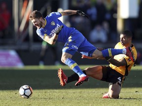 Leeds United's Mateusz Klich, left, is tackled by Newport County's Joss Labadie, during their English FA Cup, Third Round soccer match at Rodney Parade in Newport, England, Sunday Jan. 7, 2018.