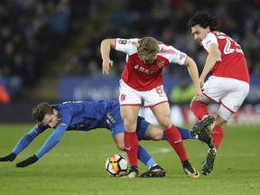 Leicester City's Adrien Silva, left, battles for the ball with Fleetwood Town's Kyle Dempsey and Markus Schwabl, right, during the FA Cup soccer replay Leicester City versus Fleetwood Town at the King Power Stadium, Leicester, England, Tuesday Jan. 16, 2018.