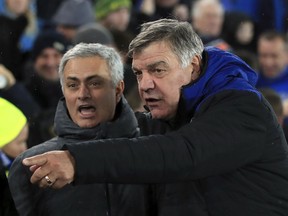 Manchester United manager Jose Mourinho, left and Everton manager Sam Allardyce react, during the English Premier League soccer match between Everton and Manchester United, at Goodison Park, in Liverpool, England, Monday, Jan. 1, 2018.