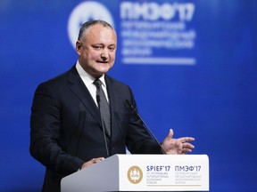 FILE- In this Friday, June 2, 2017 file photo, Moldovan President Igor Dodon addresses the St. Petersburg International Economic Forum in St. Petersburg, Russia. Moldova's Constitutional Court has temporarily stripped the country's pro-Moscow president Dodon of his duties for his refusal to endorse new ministers in a political standoff, it was reported Tuesday, Jan. 2, 2018.