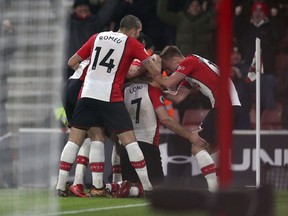 Southampton's Shane Long, centre, celebrates scoring his side's first goal of the game with team-mates during the English Premier League soccer match against Crystal Palace at St Mary's Stadium, Southampton, England, Tuesday, Jan. 2, 2018.