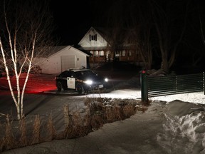 An OPP officer sits in his car in a driveway north of Madoc, Ont., on Thursday January 18, 2018. Months after dismissing growing fears about a potential serial killer prowling Toronto's gay village, police said Thursday they have arrested a man they believe is responsible for the presumed deaths of at least two men who disappeared from the neighbourhood. Bruce McArthur, a 66-year-old Toronto man, was arrested and charged with first-degree murder Thursday morning in the presumed deaths of Selim Esen and Andrew Kinsman, both reported missing from the Church and Wellesley streets area at separate times last year, police said. The men's bodies have not been found, but police said they were combing through five properties - four in Toronto, one in Madoc, Ont. - connected to McArthur, a self-employed landscaper.