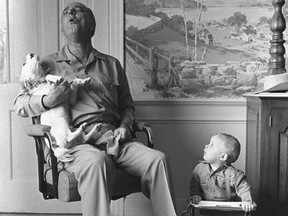 President Lyndon B. Johnson sings with his dog, Yuki, at the LBJ ranch near Stonewall, Texas, while his grandson, Patrick Lyndon Nugent, looks on, on Jan. 6, 1968.