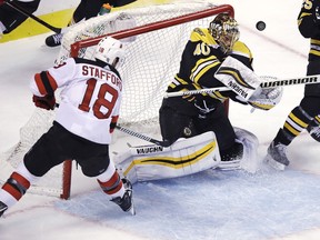 Boston Bruins goaltender Tuukka Rask (40) makes a save on a shot by New Jersey Devils right wing Drew Stafford (18) during the first period of an NHL hockey game in Boston on Tuesday, Jan. 23, 2018.