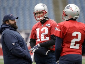 New England Patriots defensive coordinator Matt Patricia, left, speaks with quarterbacks Tom Brady (12) and Brian Hoyer (2) during an NFL football practice, Wednesday, Jan. 17, 2018, at Gillette Stadium, in Foxborough, Mass.