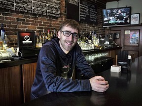 In this Sunday, Jan. 28, 2018, photo, Jeff John, of Boston, general manager of Common Ground Bar and Grill, stands for a photograph at the restaurant, in Boston. When customers watch the Super Bowl at Common Ground Bar and Grill on Sunday, waiters and bartenders will be pausing now and then to watch, as well. John may need to remind them to work, but he also understands his staff wants to see if the New England Patriots will win their third NFL title in four years.