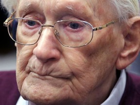 FILE - In this July 15, 2015 file photo then 94-year-old former SS sergeant Oskar Groening listens to the verdict of his trial at a court in Lueneburg, Germany. Groening has filed an appeal for clemency in a final bid to avoid serving his sentence as an accessory to murder the dpa news agency reported Monday Jan. 15, 2018.  He was convicted in 2015 of accessory to the murder of 300,000 Jews and sentenced to four years in prison.