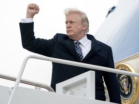 President Donald Trump gestures as he boards Air Force One at Andrews Air Force Base, Md., Friday, Jan. 12, 2018, to travel to Palm Beach International Airport in West Palm Beach, Fla. (AP Photo/Andrew Harnik.