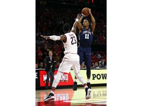 Penn State forward Lamar Stevens, right, shoots over Maryland forward Bruno Fernando, of Angola, in the first half of an NCAA college basketball game in College Park, Md., Tuesday, Jan. 2, 2018.