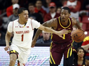 Minnesota guard Dupree McBrayer, right, drives past Maryland guard Anthony Cowan during the first half of an NCAA college basketball game in College Park, Md., Thursday, Jan. 18, 2018.