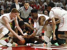 Michigan State forward Jaren Jackson Jr., second from left, tries to maintain possession as he is pressured by, from left to right, Maryland guard Kevin Huerter, forward Bruno Fernando, of Angola, and guard Anthony Cowan in the first half of an NCAA college basketball game in College Park, Md., Sunday, Jan. 28, 2018.