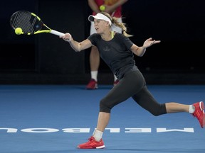 Denmark's Caroline Wozniacki makes a forehand return during a practice session on Rod Laver Arena ahead of the Australian Open tennis championships in Melbourne, Australia Friday, Jan. 12, 2018.