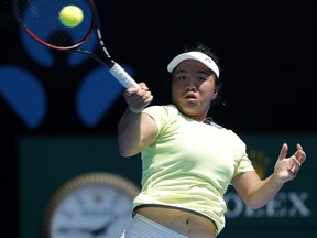 Taiwan's Liang En Shuo makes a forehand return to France's Clara Burel during the girl's singles final at the Australian Open tennis championships in Melbourne, Australia, Saturday, Jan. 27, 2018.