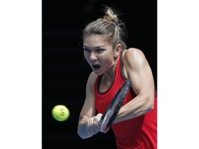 Romania's Simona Halep makes a backhand return to United States' Lauren Davis during their third round match at the Australian Open tennis championships in Melbourne, Australia, Saturday, Jan. 20, 2018.