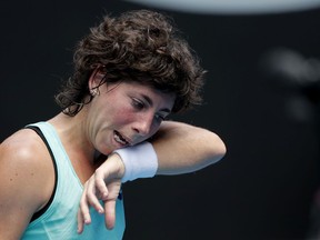 Spain's Carla Suarez Navarro wipes sweat from her face during her fourth round match against Anett Kontaveit of Estonia at the Australian Open tennis championships in Melbourne, Australia, Sunday, Jan. 21, 2018.