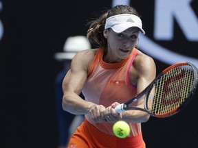 Romania's Ana Bogdan makes backhand return to United States' Madison Keys during their third round match at the Australian Open tennis championships in Melbourne, Australia, Saturday, Jan. 20, 2018.