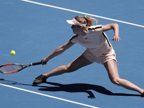 Ukraine's Elina Svitolina reaches for a return to Belgium's Elise Mertens during their quarterfinal at the Australian Open tennis championships in Melbourne, Australia, Tuesday, Jan. 23, 2018.