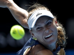 Denmark's Caroline Wozniacki eyes the ball to make a return to Belgium's Elise Mertens during their semifinal at the Australian Open tennis championships in Melbourne, Australia, Thursday, Jan. 25, 2018.