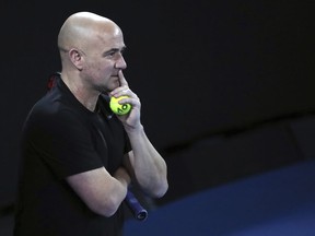 Novak Djokovic's coach Andre Agassi watches him train during a practice session ahead of the Australian Open tennis championships in Melbourne, Australia, Saturday, Jan. 13, 2018.