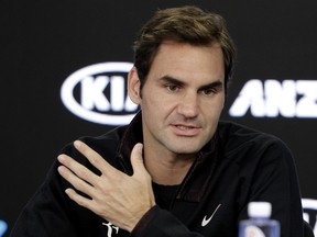 Switzerland's Roger Federer answers questions during a press conference at the Australian Open tennis championships in Melbourne, Australia, Sunday, Jan. 14, 2018.