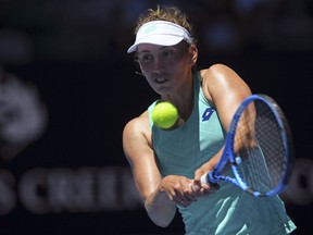 Belgium's Elise Mertens makes a backhand return to Ukraine's Elina Svitolina during their quarterfinal at the Australian Open tennis championships in Melbourne, Australia, Tuesday, Jan. 23, 2018.