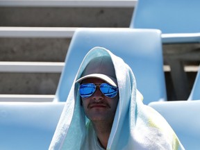 A spectator watches the third round match between Britain's Kyle Edmund and Georgia's Nikoloz Basilashvili at the Australian Open tennis championships in Melbourne, Australia, Friday, Jan. 19, 2018.