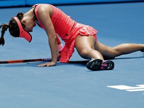 United States' Lauren Davis falls during her third round match against Romania's Simona Halep at the Australian Open tennis championships in Melbourne, Australia, Saturday, Jan. 20, 2018.