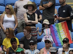 A fan waves a rainbow flag while watching the first round match on Margaret Court Arena between United States' Sloane Stephens and China's Zhang Shuai at the Australian Open tennis championships in Melbourne, Australia, Monday, Jan. 15, 2018. Marriage equality proponents draped themselves in rainbow flags at Margaret Court Arena on the first day of the Australian Open to protest Australian tennis great Margaret Court's controversial views on gay marriage and the broader lesbian, gay, bisexual and transgender community.