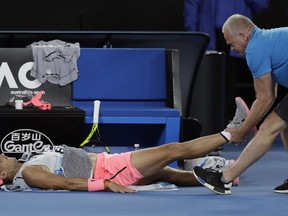 Spain's Rafael Nadal receives treatment from a trainer during his quarterfinal against Croatia's Marin Cilic at the Australian Open tennis championships in Melbourne, Australia, Tuesday, Jan. 23, 2018.