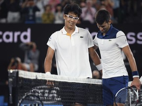 South Korea's Chung Hyeon, left, is congratulated by Serbia's Novak Djokovic after winning their fourth round match at the Australian Open tennis championships in Melbourne, Australia, Monday, Jan. 22, 2018.