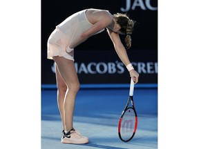 Petra Kvitova of the Czech Republic bends over while playing Germany's Andrea Petkovic during their first round match at the Australian Open tennis championships in Melbourne, Australia, Tuesday, Jan. 16, 2018.