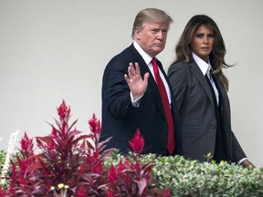 In this Wednesday, Oct. 11, 2017 file photo, President Donald Trump walks along the Colonnade with first lady Melania Trump on his way to board the Marine One helicopter on the South Lawn of the White House in Washington for a short trip to Andrews Air Force Base, Md., and then onto Harrisburg, Pa.